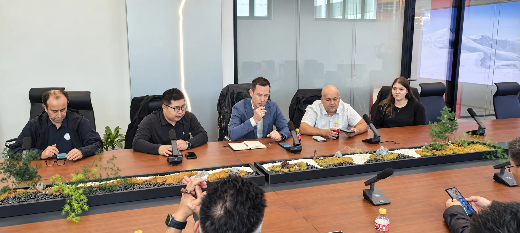Customers discussing business around a meeting table
