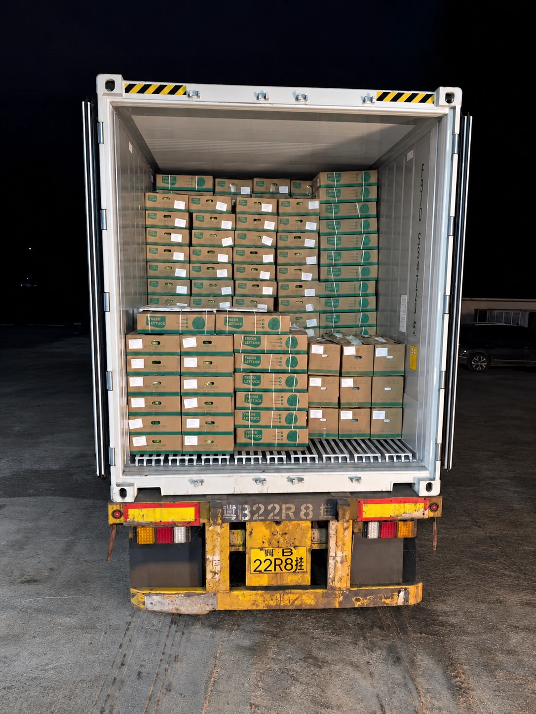 Supplied night-time photograph of cartons loaded in a container